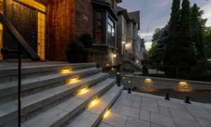 custom retaining wall with glass lighting railings